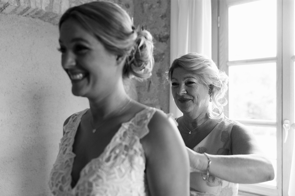 Fotografo Matrimonio Lago di Garda La madre della sposa sistema con cura il vestito della figlia