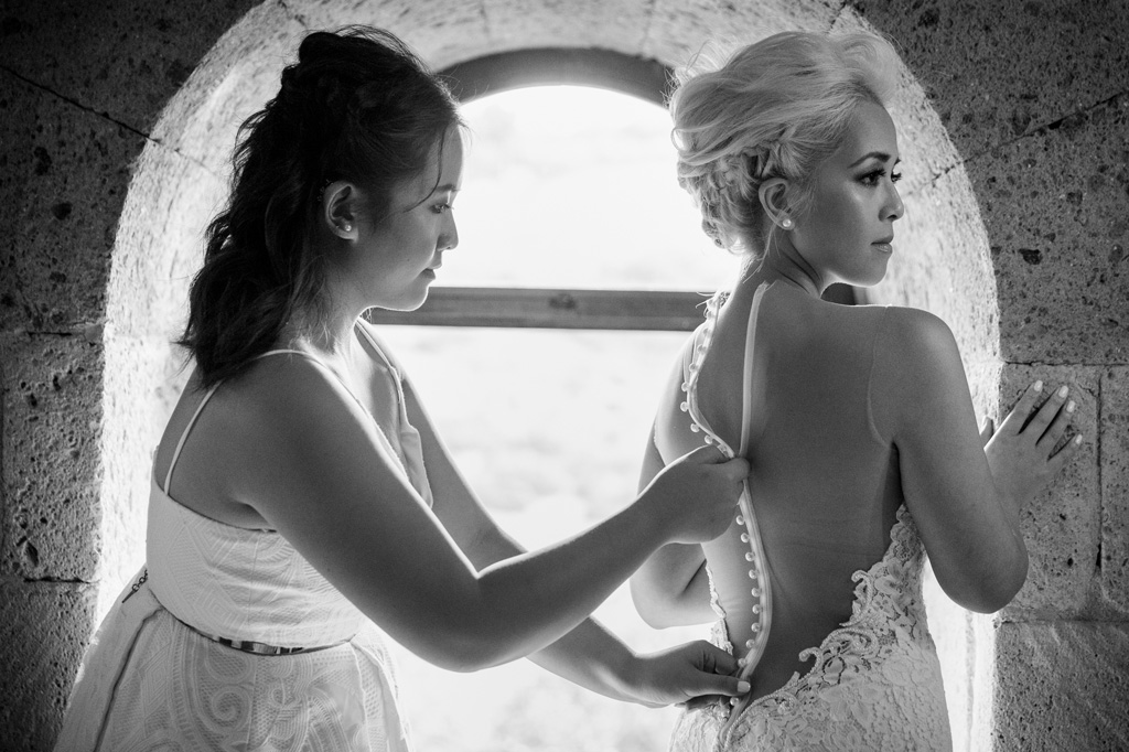 Fotografo Matrimonio Orvieto La tesimone sistema il vestito della sposa