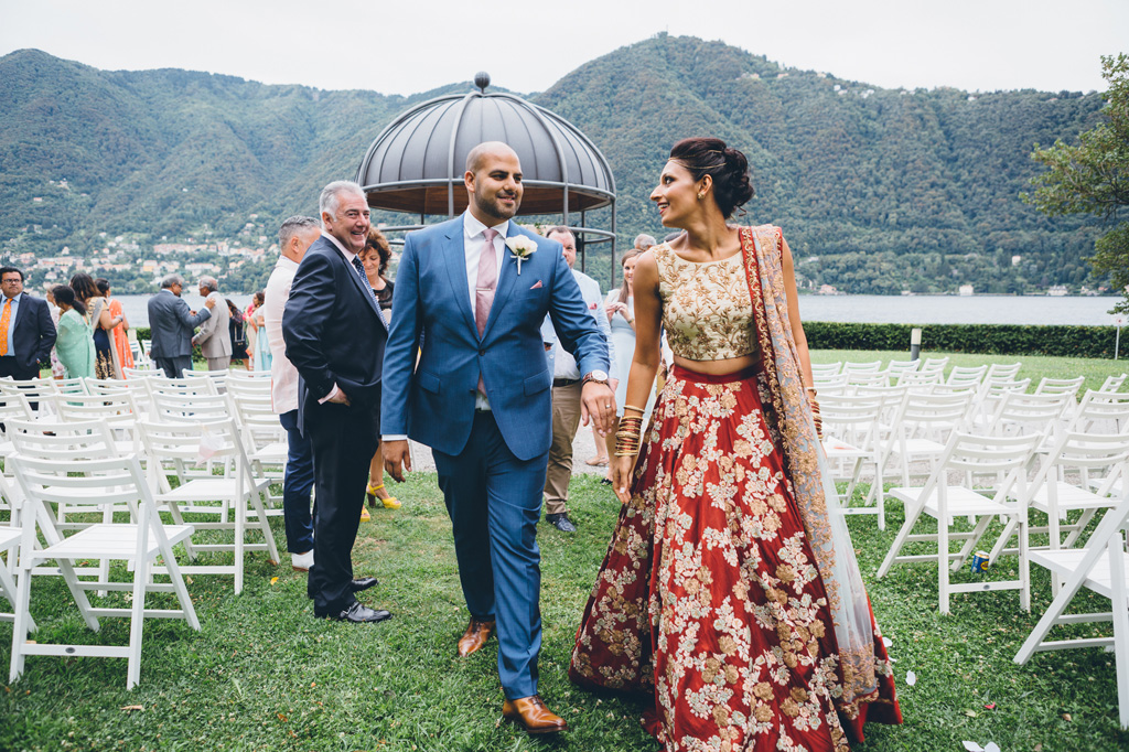 Fotografo Matrimonio Villa Erba I due sposi mano nella mano attraversano