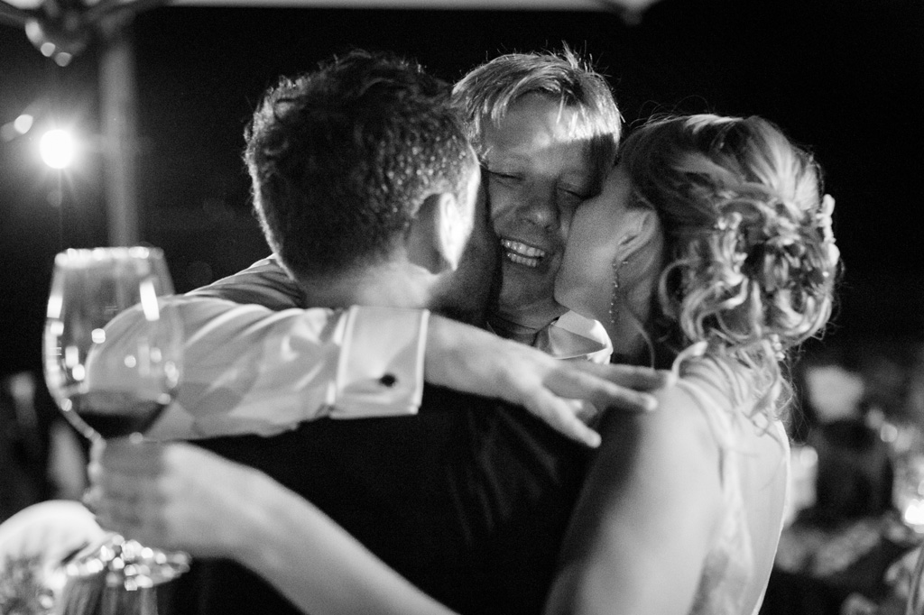 Fotografo Matrimonio Langhe Alcuni ospiti baciano e abbracciano gli sposi