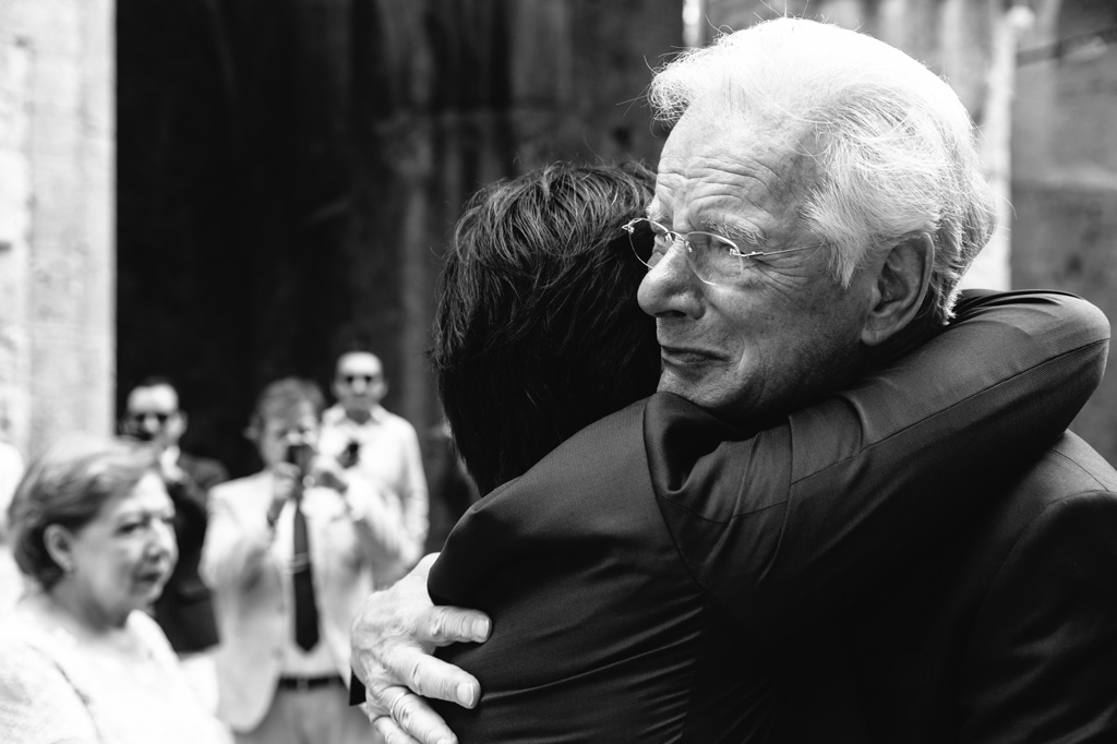 Fotografo Matrimonio Basilica San Galgano Toscana Il padre della sposa abbraccia lo sposo commosso