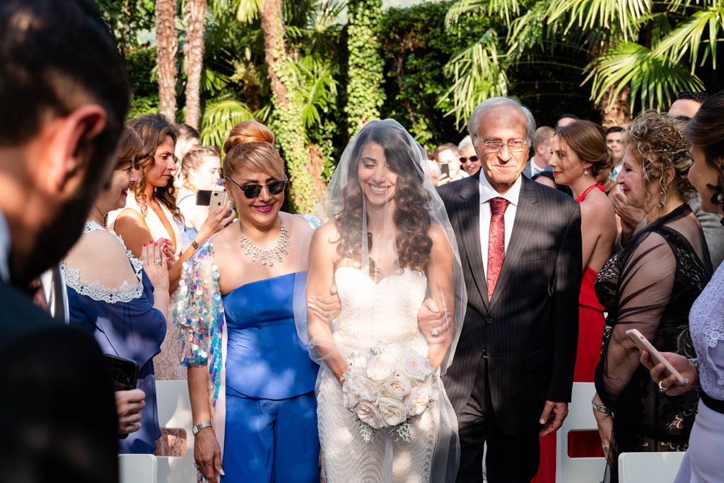 Fotografo Matrimonio Lago di Como Hilton Villa Parravicini Revel I genitori della sposa accompagnano Samin alla cerimonia